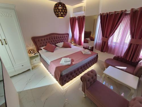 a bedroom with a large bed and purple curtains at Villa Vista Real in Kotor