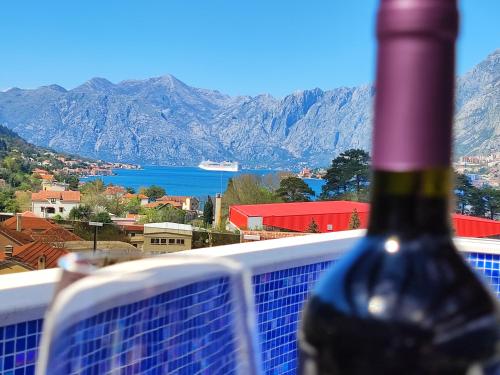 a bottle of wine sitting on top of a balcony at Villa Vista Real in Kotor