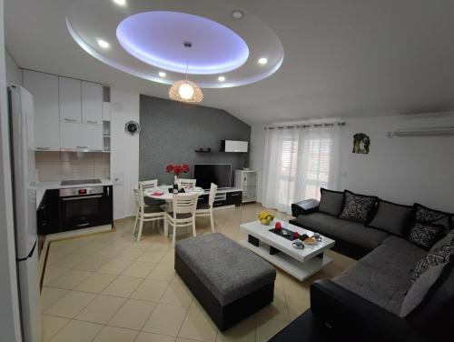 a living room with a couch and a table at Villa Vista Real in Kotor