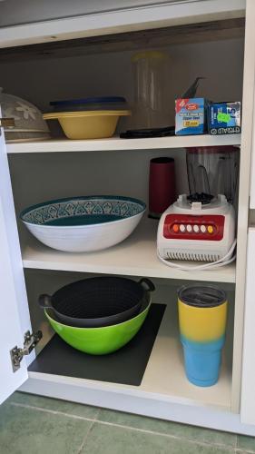 a shelf with bowls and other items on it at Breathtaking View - Playa Lagun - Curacao in Lagun
