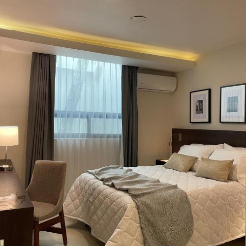 a bedroom with a large bed and a window at HIDALGO 119 - TERRAZA Y SUITES in Zacatecas