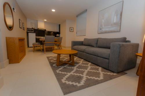 a living room with a couch and a table at HIDALGO 119 - TERRAZA Y SUITES in Zacatecas