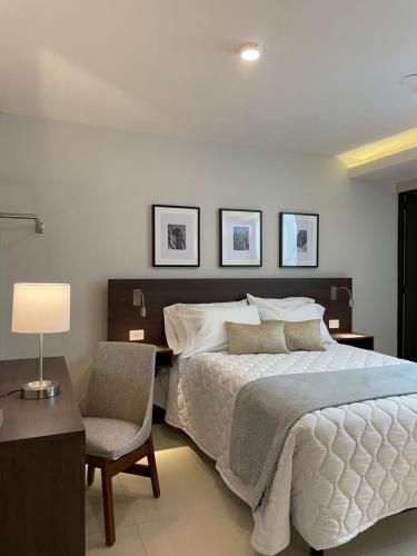 a bedroom with a bed and a desk and a chair at HIDALGO 119 - TERRAZA Y SUITES in Zacatecas