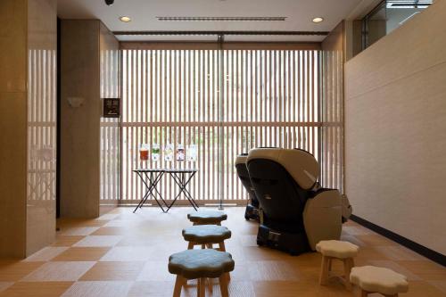 a room with stools and a table and a window at Yutoriro Bandai Atami in Koriyama