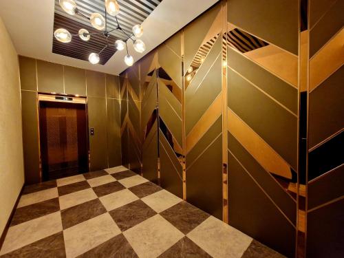 a dressing room with a checkered floor at New West Hotel in Ulaanbaatar