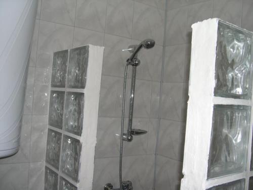 a shower with a glass door in a bathroom at 6 Treti Mart street 2 floor in Primorsko