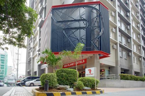 a building with a sign on the side of it at Red Planet Makati Avenue Manila in Manila
