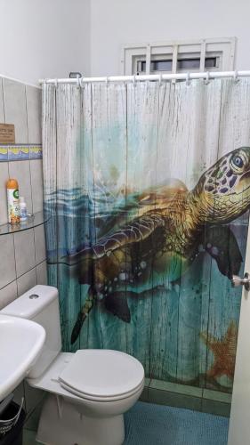 a bathroom with a shower curtain with a sea turtle at Breathtaking View - Playa Lagun - Curacao in Lagun