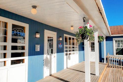 a porch of a house with a blue wall at Glenghorm Beach Resort in Ingonish