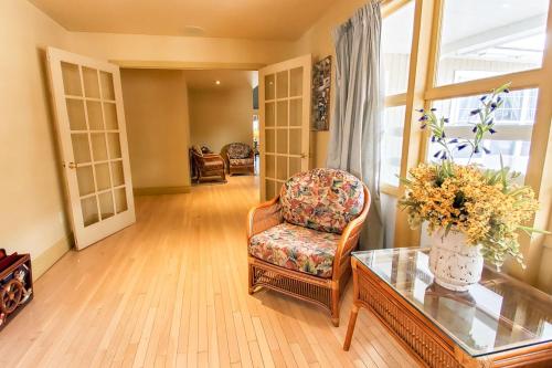 a living room with a chair and a glass table at Glenghorm Beach Resort in Ingonish