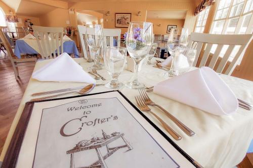 a table with a white table cloth with a picture on it at Glenghorm Beach Resort in Ingonish