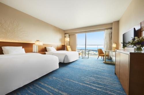 a hotel room with two beds and a television at GRAND NIKKO AWAJI in Awaji