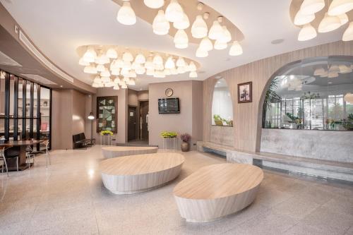a lobby with two circular tables in a building at I Pavilion Hotel Phuket in Phuket Town