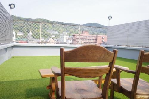a wooden chair sitting on top of a roof at Kyoto-Gion Tourist House in Kyoto