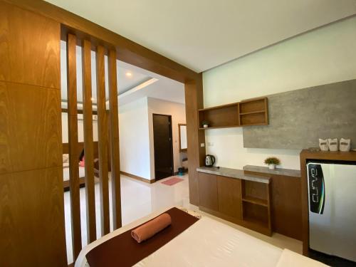 a room with a kitchen with a bed in it at Vipa Tropical Resort in Ao Nang Beach