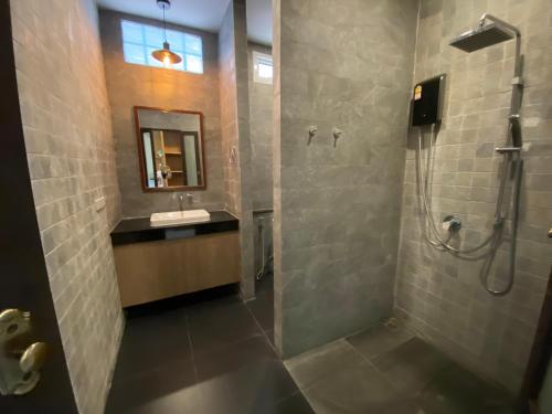 a bathroom with a shower and a sink at Vipa Tropical Resort in Ao Nang Beach
