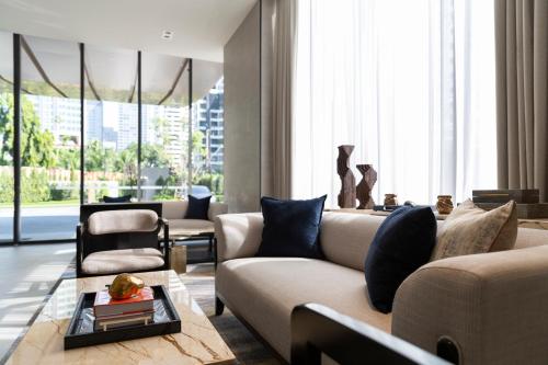 a living room with a couch and a table at Ascott Thonglor Bangkok in Bangkok