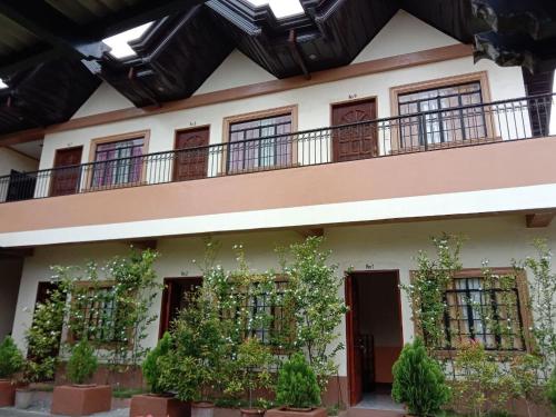 a building with a balcony and plants on it at RedDoorz @ Solid Rock Guest House Baler in Dipaculao