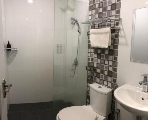 a bathroom with a shower and a toilet and a sink at M Design Hotel@KLIA,Sepang in Sepang
