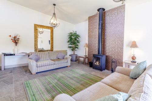 a living room with two couches and a fireplace at The Croft in Great Malvern