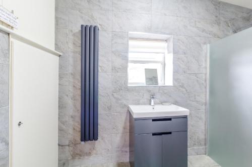 a bathroom with a sink and a shower at The Croft in Great Malvern