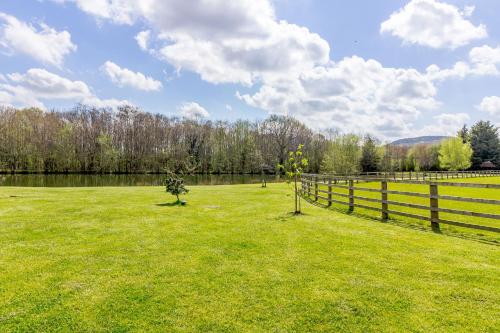 a grassy field with a fence and a field at The Croft in Great Malvern