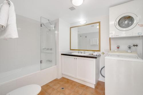 a white bathroom with a sink and a shower at Calypso Plaza Resort Unit 429 in Gold Coast