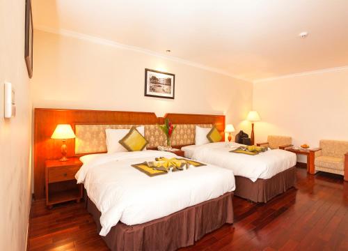 Cama o camas de una habitación en First Hotel