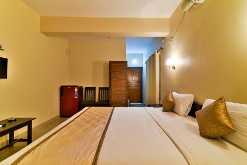 a bedroom with a large bed in a room at Baga Fantacia Beach Inn in Baga