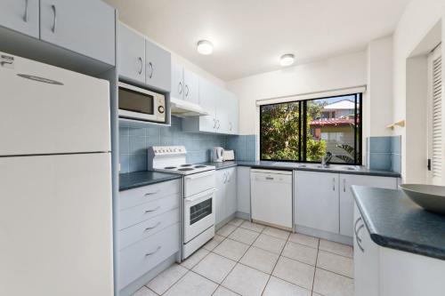 a kitchen with white appliances and a window at Radburn Ondine Close 3 17 in Nelson Bay