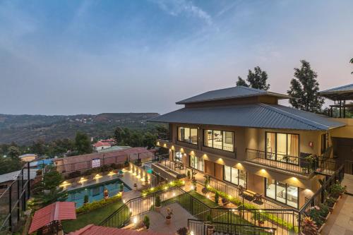 an aerial view of a house with a pool at SaffronStays Cinco Elementos, Panchgani - stunning valley view pool villa in Panchgani