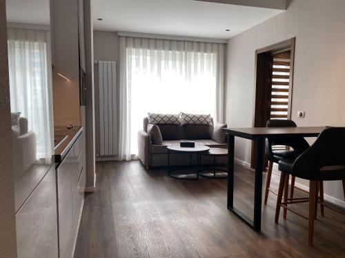 a living room with a couch and a table at Golden Horn Apart Hotel in Baku