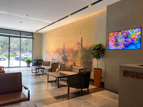 a waiting room with couches and a painting on the wall at Golden Horn Apart Hotel in Baku