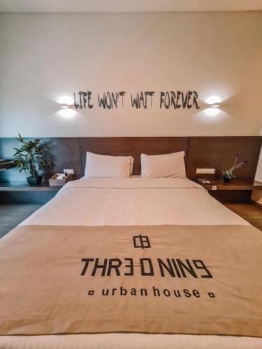 a bed with a sign that reads life wont wait forever at Three O Nine Hotel in Beirut