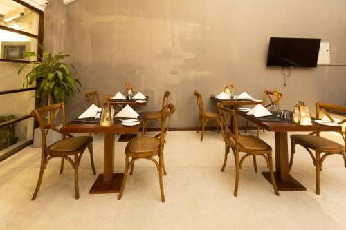 a dining room with wooden tables and chairs at Heritage Boutique by Seven Angels in Kandy