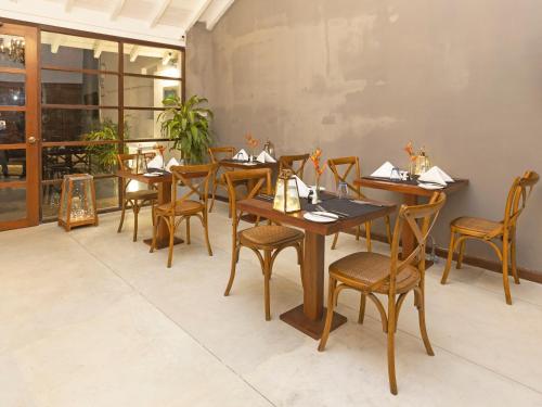 a dining room with wooden tables and chairs at Heritage Boutique by Seven Angels in Kandy