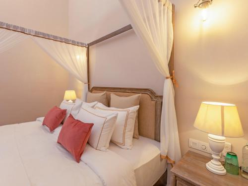 a bedroom with a bed with red and white pillows at Heritage Boutique by Seven Angels in Kandy