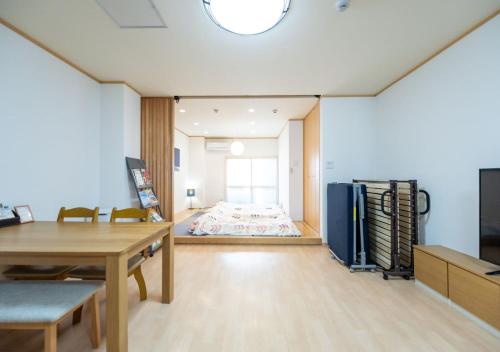 徳島市にあるHOSTEL PAQ 徳島のテーブルとベッドが備わる部屋