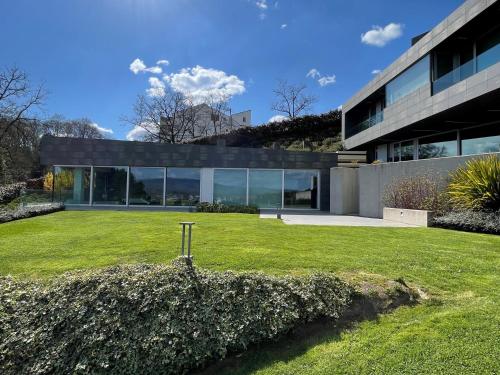 an exterior view of a house with a yard at Tres Prismas Exclusive in Sarria