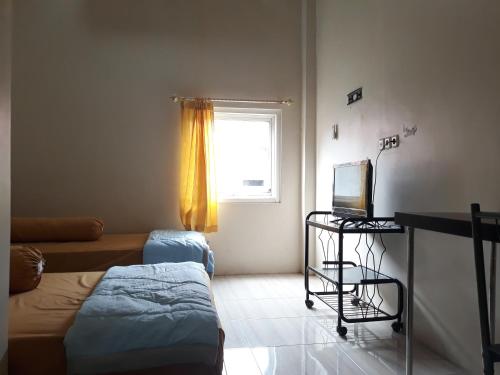 Posteľ alebo postele v izbe v ubytovaní OYO 91162 Homestay Ansyariah Syariah