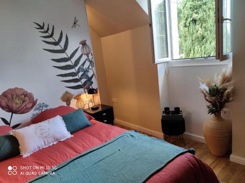 a bedroom with a bed and a plant on the wall at Rêves & Rivière in Rivière