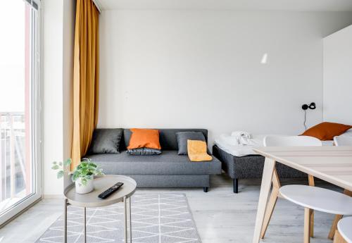 a living room with a couch and a table at Hiisi Homes Nokia Nansonkatu in Nokia