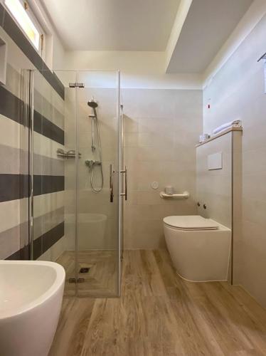 a bathroom with a shower and a toilet and a sink at Hotel San Michele in San Gimignano