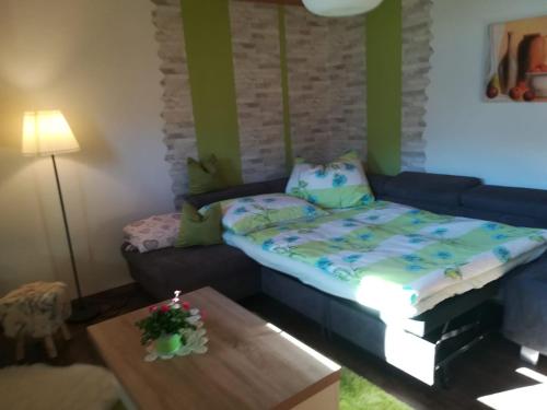 a living room with a bed and a coffee table at Ferienwohnung Familie Fiechtl in Fügenberg