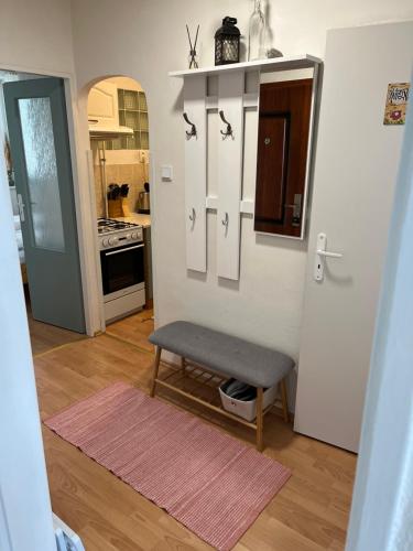 a kitchen with a bench in the middle of a room at Apartman Breza in Vysoké Tatry