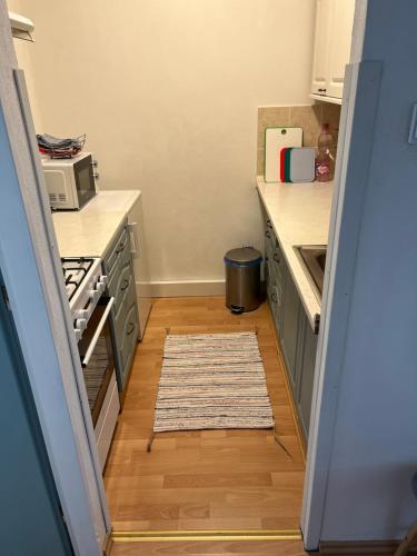 a kitchen with a stove and a rug on the floor at Apartman Breza in Vysoké Tatry