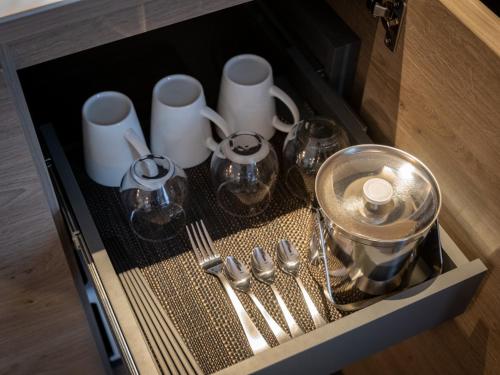 a drawer filled with silver utensils in a cabinet at Tokyu Stay Hakodate Asaichi Akarinoyu in Hakodate