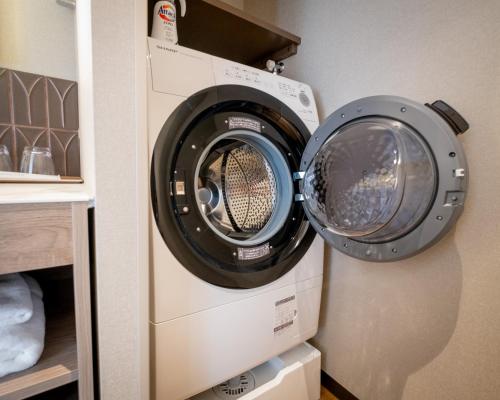 a dryer and a washing machine in a closet at Tokyu Stay Hakodate Asaichi Akarinoyu in Hakodate