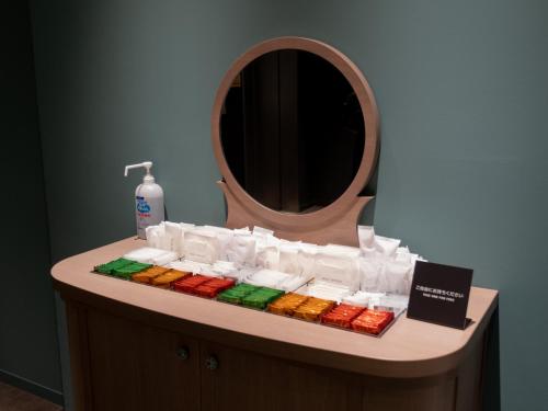 a bathroom vanity with a mirror and a sink at Tokyu Stay Hakodate Asaichi Akarinoyu in Hakodate