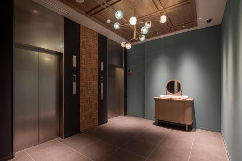 a hallway with a table and a mirror on the wall at Tokyu Stay Hakodate Asaichi Akarinoyu in Hakodate
